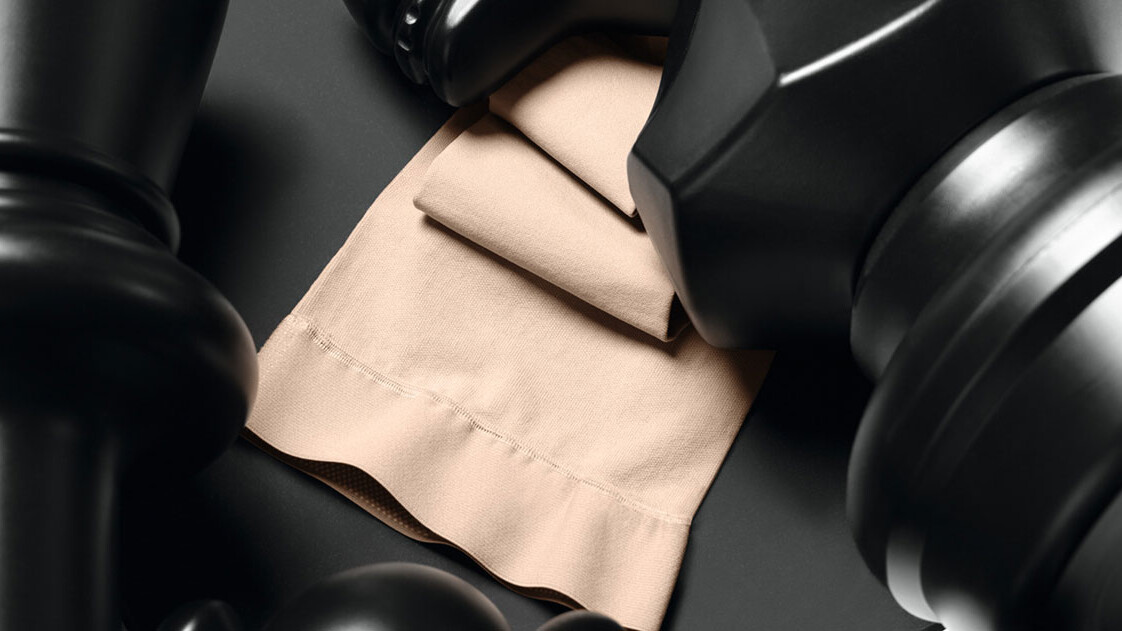 Black chess pieces are lying on a Juzo Dynamic sock Black chess pieces are lying on a Juzo Dynamic sock
