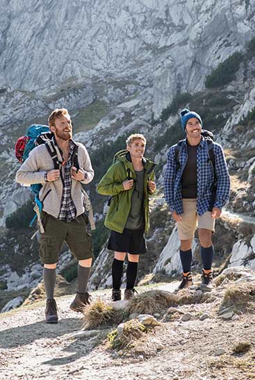 Three hiking men are wearing Juzo Products