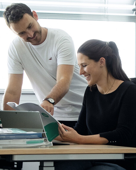 A man and a woman reading a brochure
