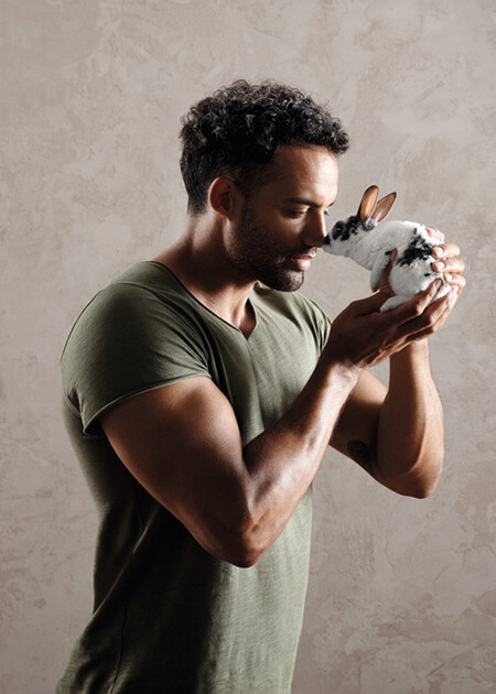 Strong man cuddling with a cute bunny