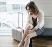 Woman putting on her travel compression stockings