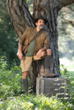 Man wearing Juzo Adventure standing in a meadow in front of a tree