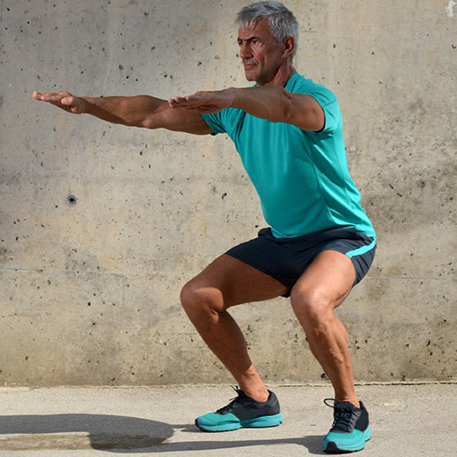Man doing a squat Man doing a squat