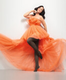 Woman wears Juzo Inspiration in cocoa and an orange tulle dress