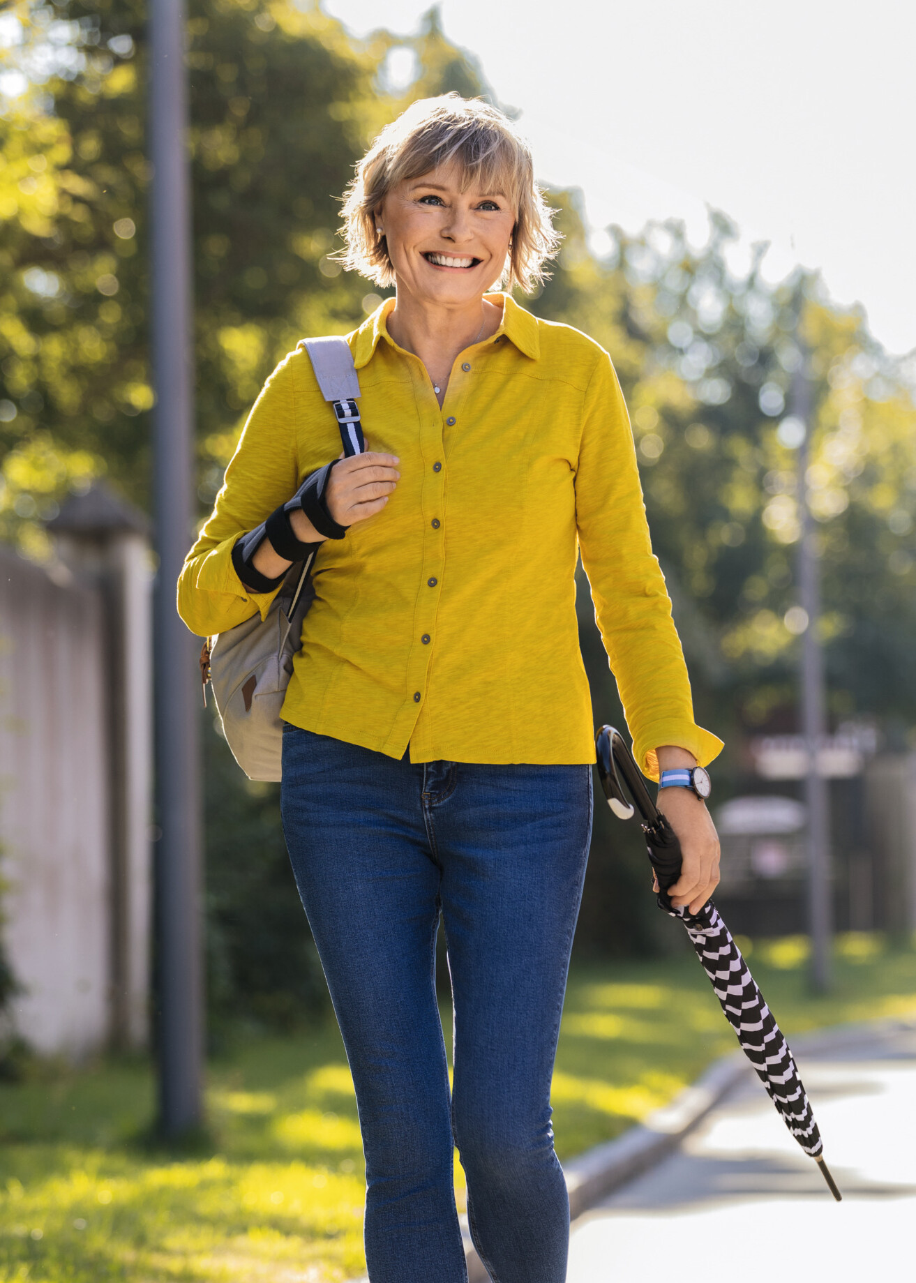 A woman in a yellow blouse is wearing a Juzo wrist brace A woman in a yellow blouse is wearing a Juzo wrist brace