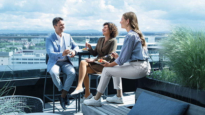 Un uomo e due donne con calze a compressione si trovano su una terrazza sul tetto Un uomo e due donne con calze a compressione si trovano su una terrazza sul tetto