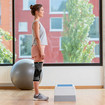 A woman standing in front of an aerobics step