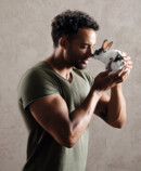 Strong man cuddling with a cute bunny