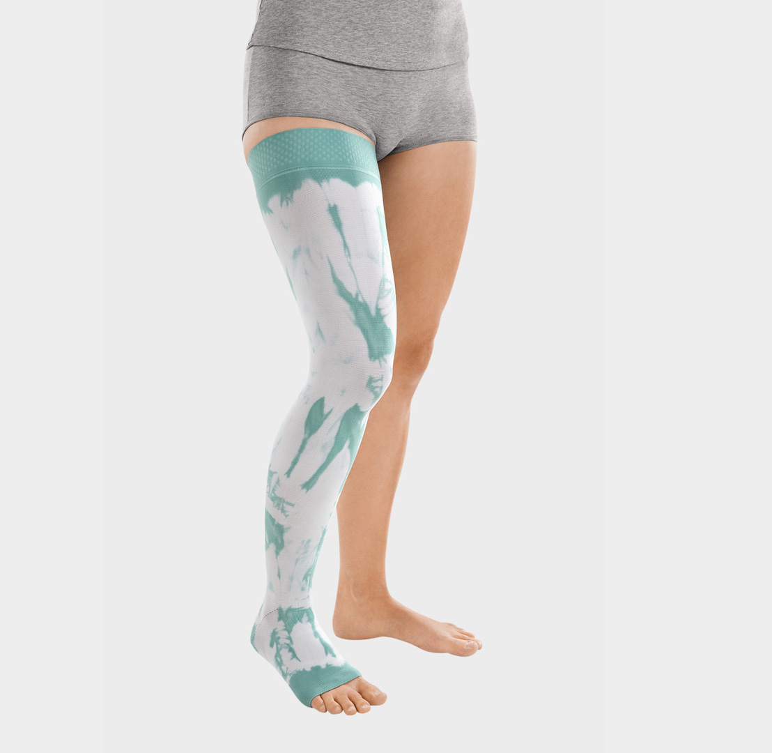 ScarComort Kompressionsstrumpf Mint-Weiß Frau trägt einen mintfarbenen ScarComfort Fine Kompressionsstrumpf mit weißem Batik-Muster